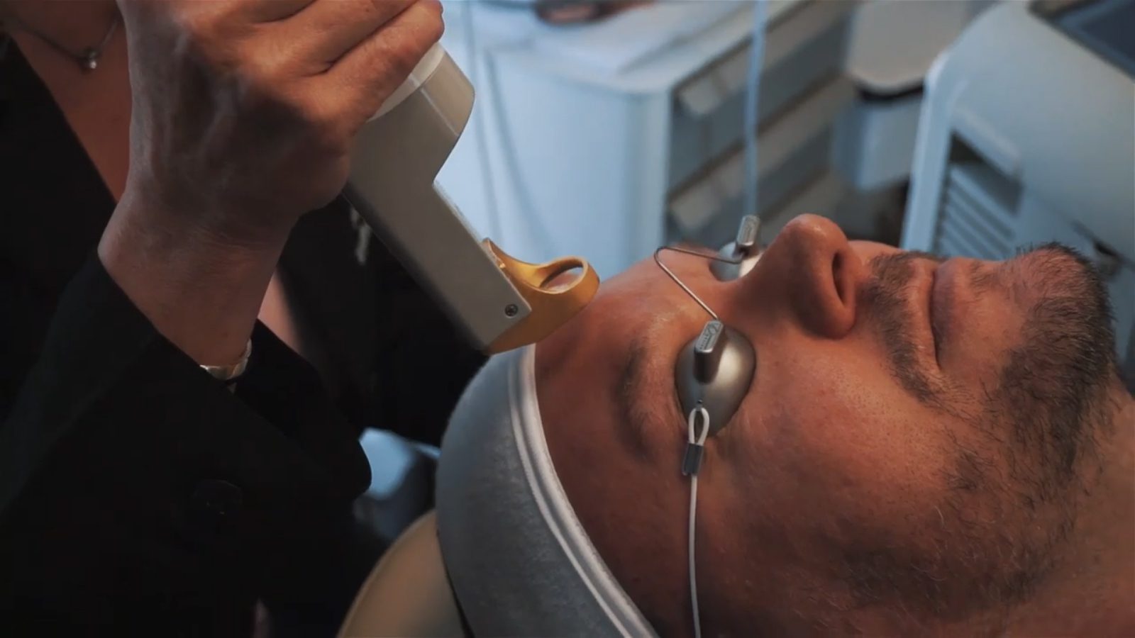 Man receiving laser facial skin treatment