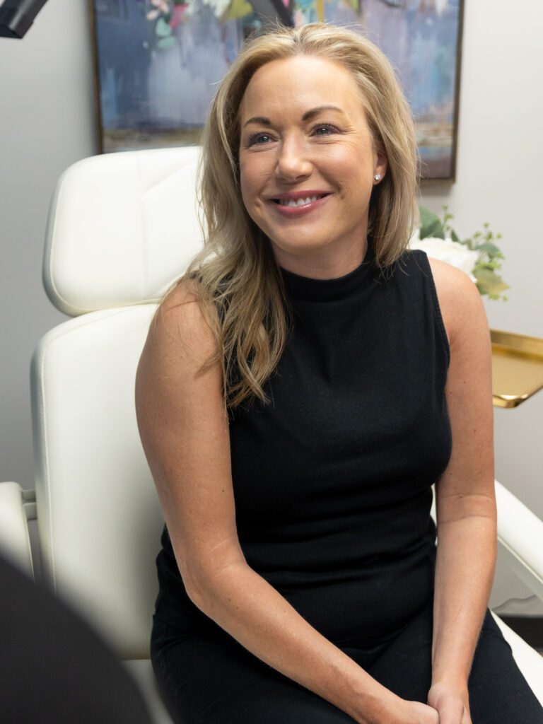 Smiling woman sitting in clinic chair