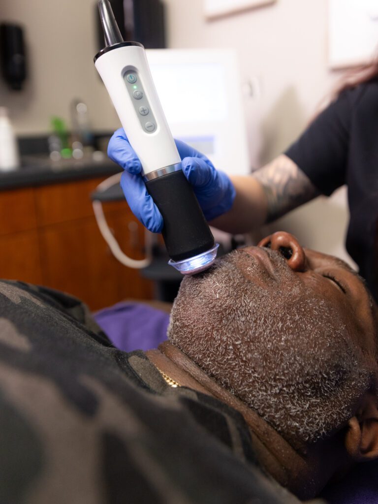 Man receiving facial laser treatment