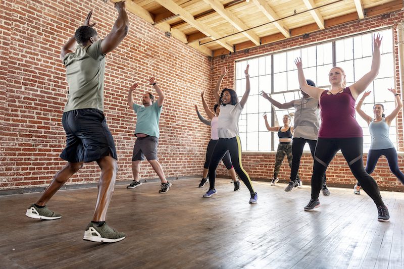 A group fitness class is doing jumping jacks and pairing exercise with semaglutide weight loss in Fort Collins.
