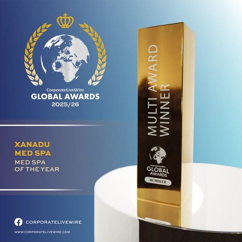 Gold trophy labeled "Multi Award Winner Global Awards" on a white table, with a blue background displaying "CorporateLiveWire Global Awards 2025/26" and "Xanadu Med Spa, Med Spa of the Year" text.