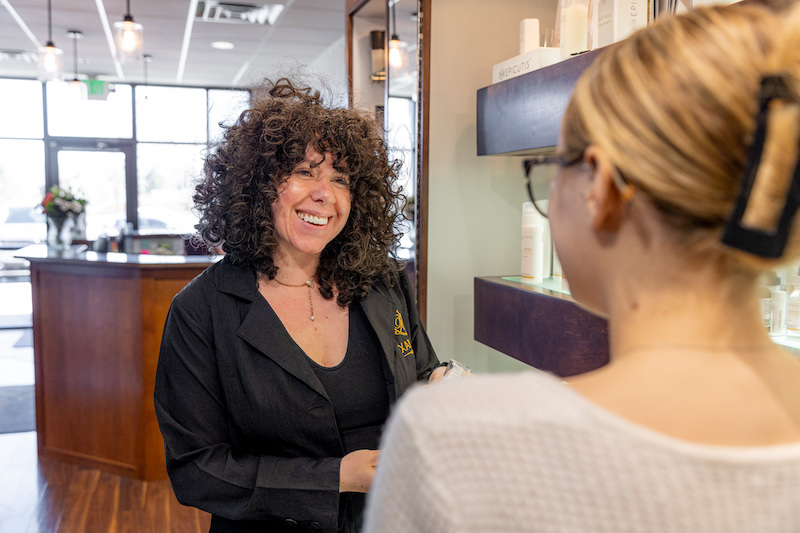 A Xanadu provider is guiding a patient through the office for her acne scar removal treatment in Fort Collins.