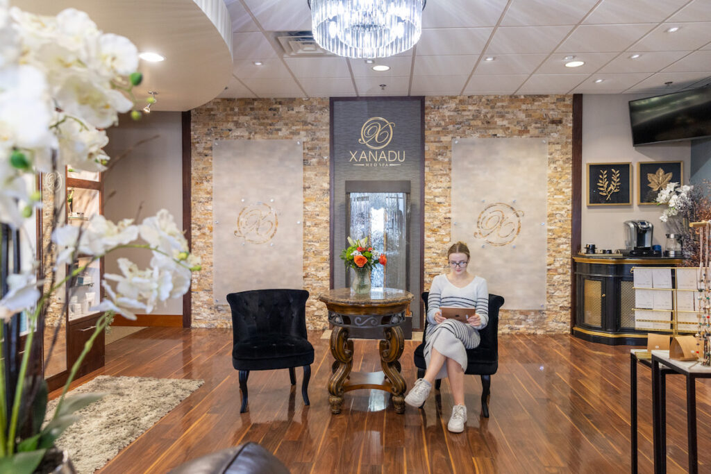 A woman is waiting in the Xanadu waiting room for her treatment for intense pulsed light. Fort Collins is home to Xanadu and all things light therapy.